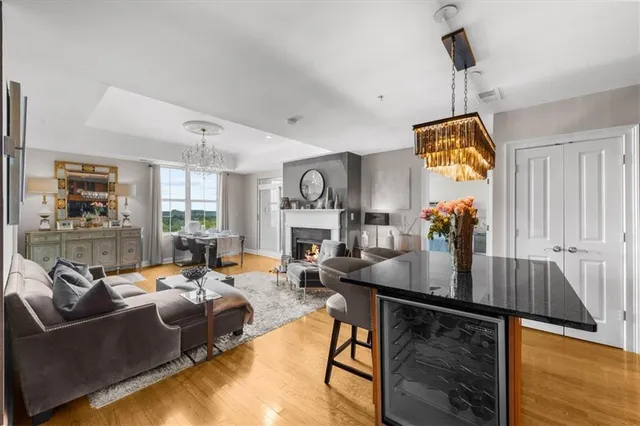 a living room with furniture and a chandelier