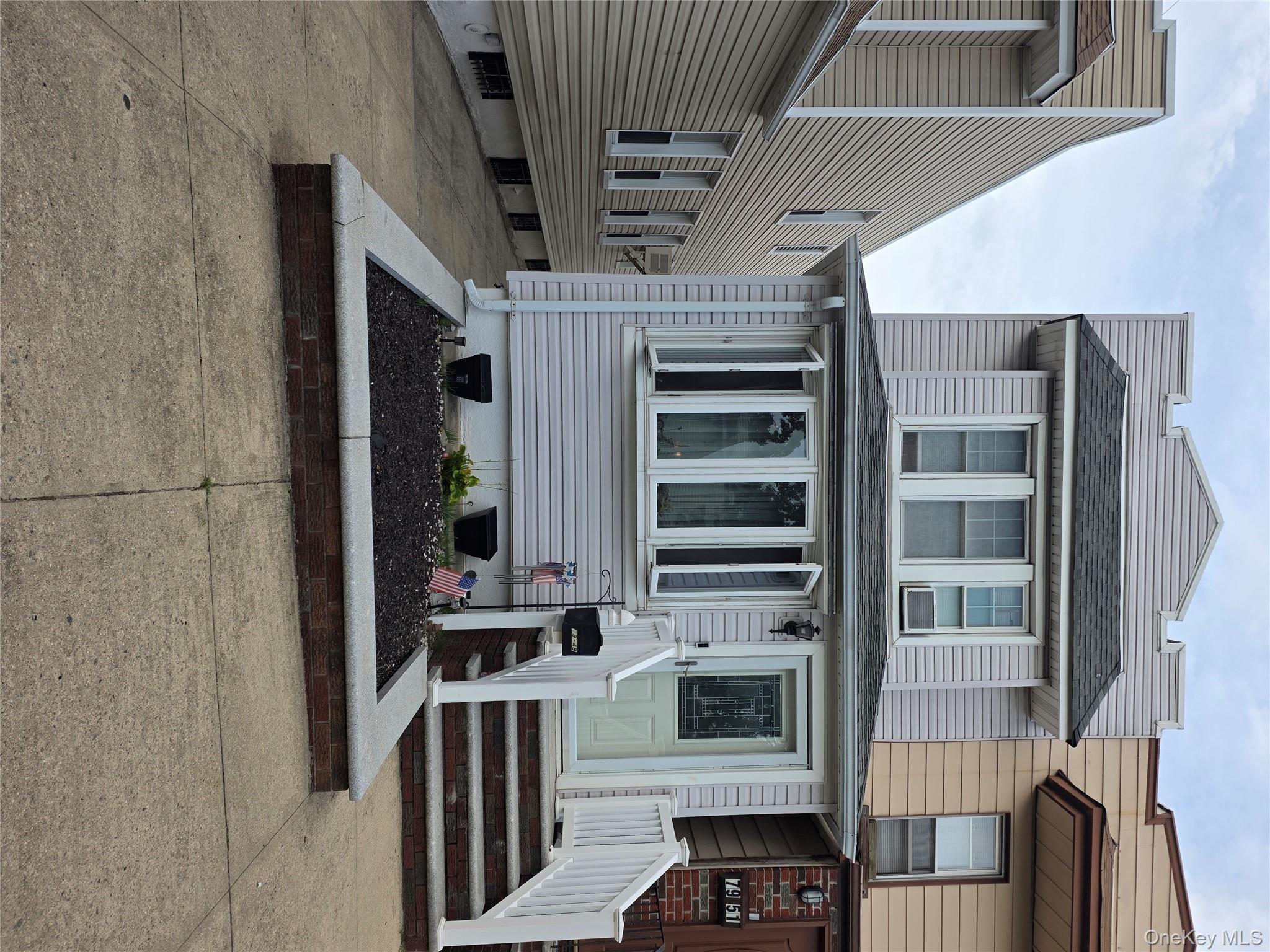 View of front of home featuring roof with shingles