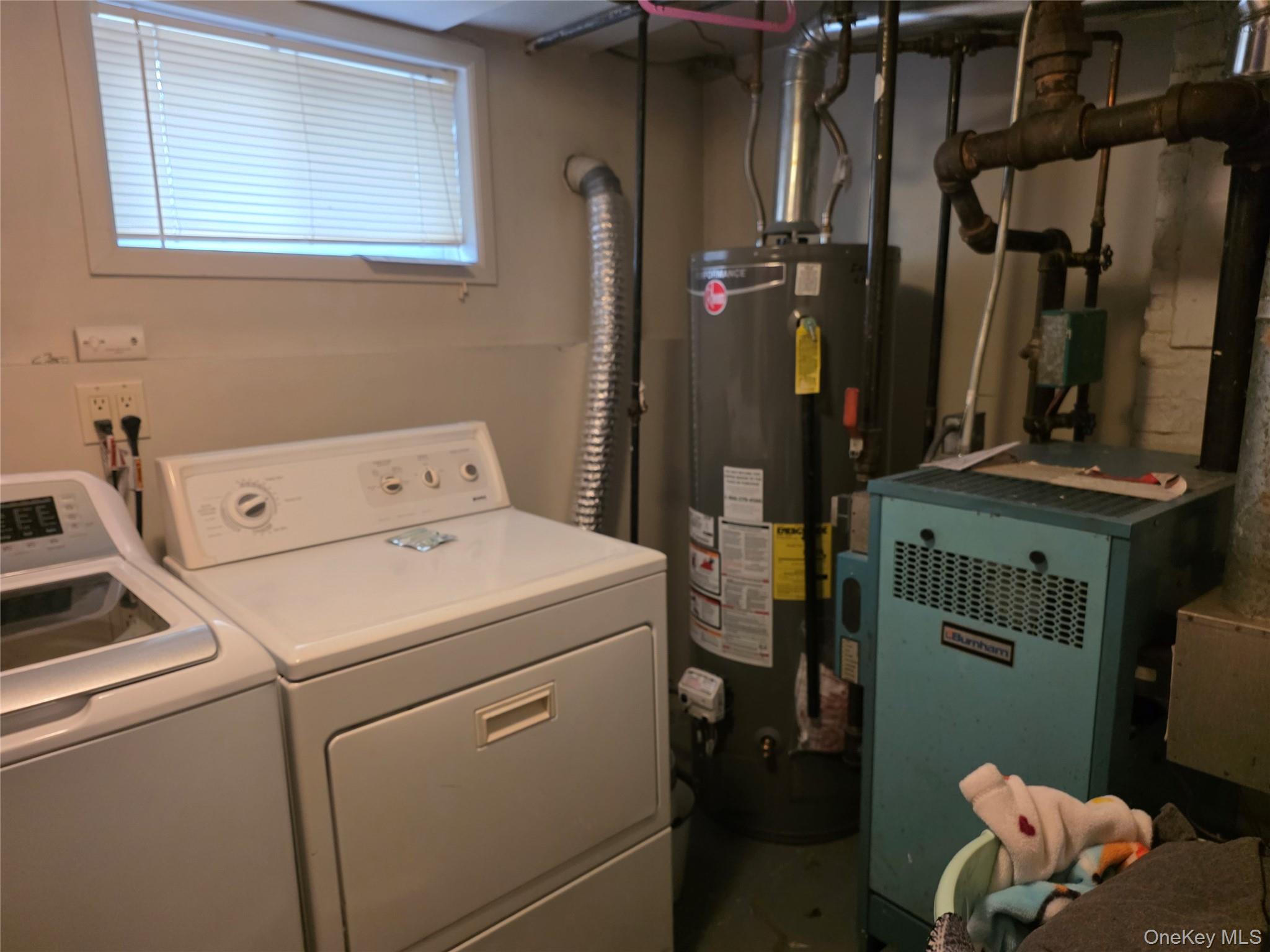 79-49 77th Road Queens, NY 11385 - Photo 12 of 12 Washroom featuring water heater, a heating unit, and washing machine and dryer