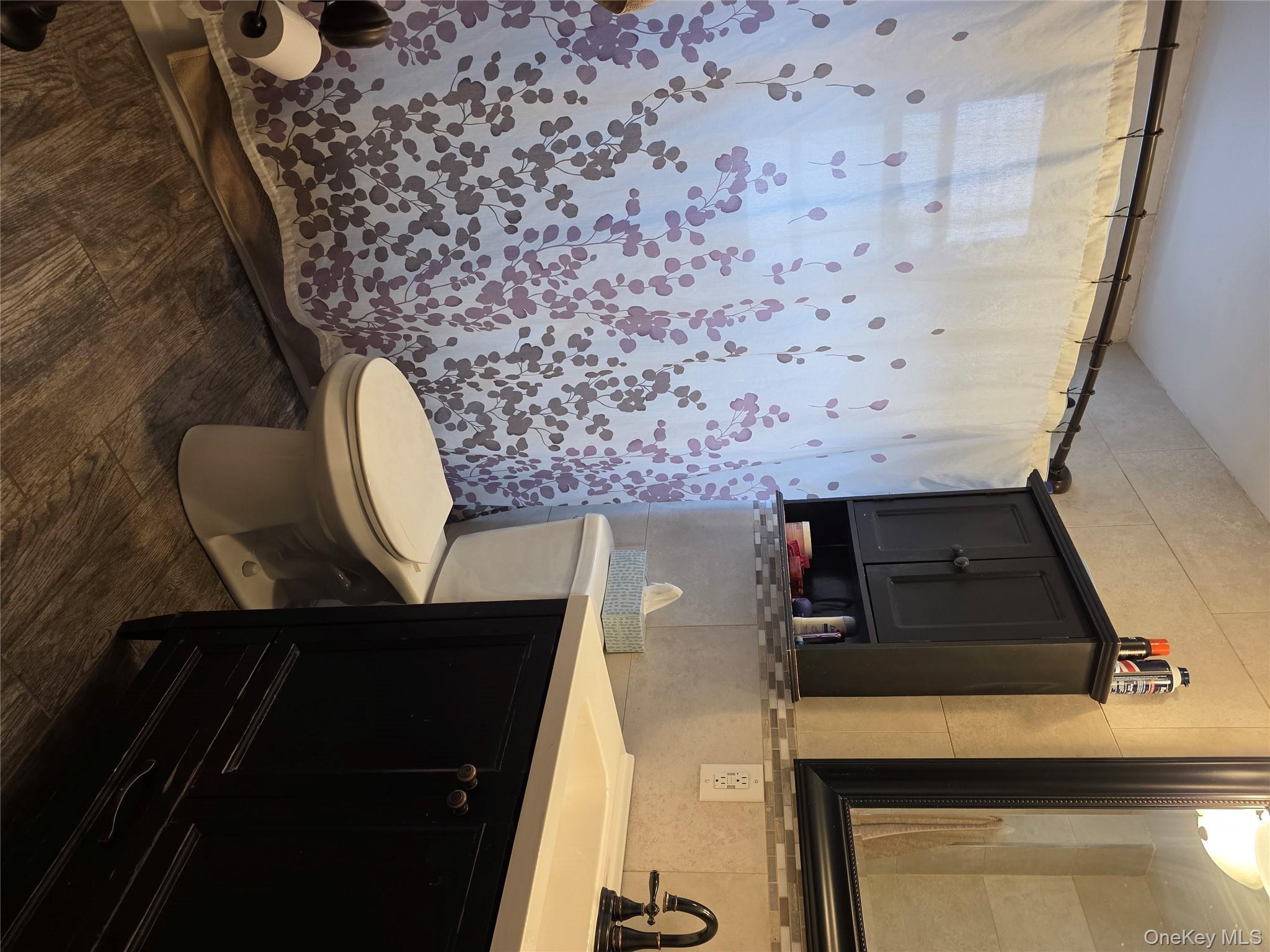 79-49 77th Road Queens, NY 11385 - Photo 7 of 12 Full bath featuring vanity, tile walls, dark wood-style flooring, tasteful backsplash, and a shower with shower curtain