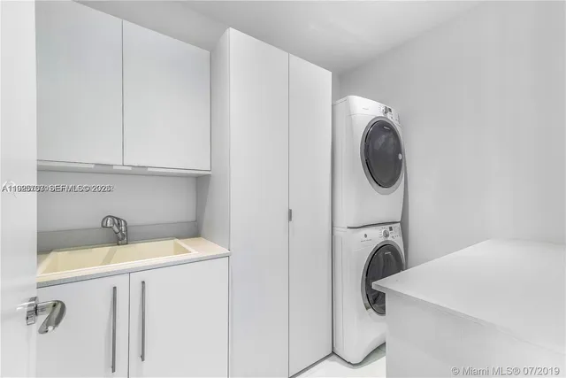 a bedroom with a bed and large window