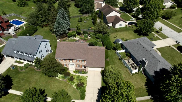 an aerial view of a house with a yard and garden