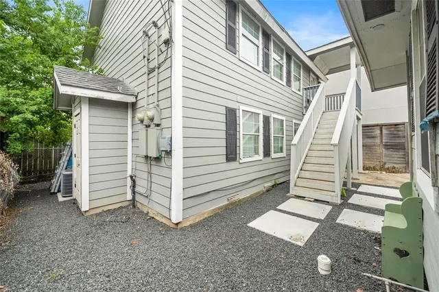 a view of a house with a yard and stairs