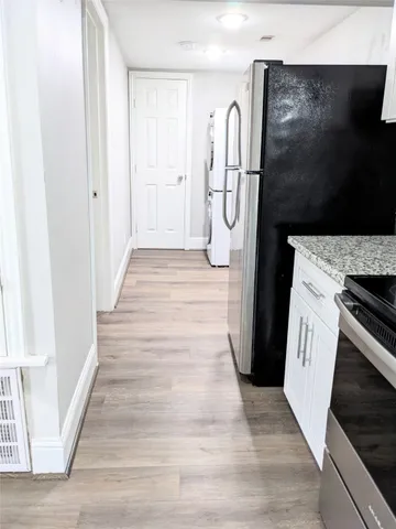 a view of a kitchen from the hallway