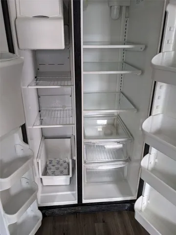 a view of walk in closet with empty racks