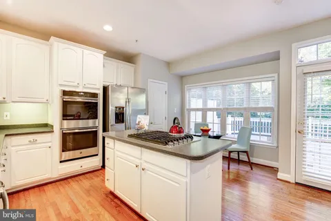 a kitchen with a stove a sink and a refrigerator