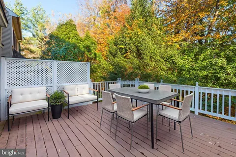 a roof deck with a table and a chairs