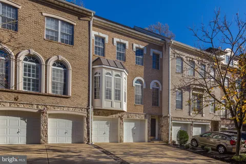 a front view of a residential apartment building with a yard