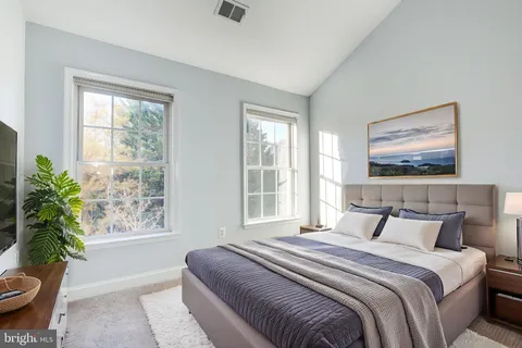 a bedroom with bed and a window
