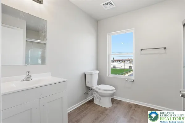 a bathroom with a sink toilet and a mirror
