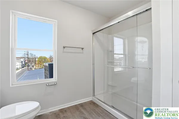 a bathroom with a window and a shower
