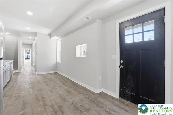 an empty room with windows and closet