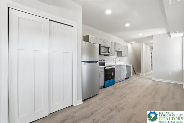 a kitchen with stainless steel appliances a refrigerator and a sink