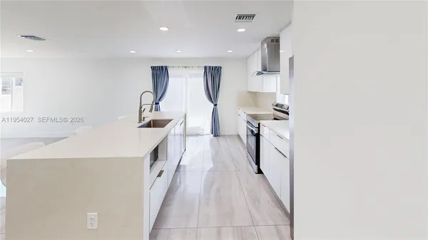 a hallway with a sink and dishwasher