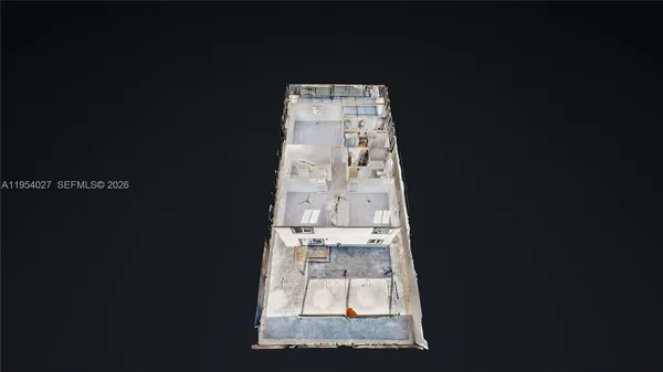 an aerial view of a houses with swing table and chairs