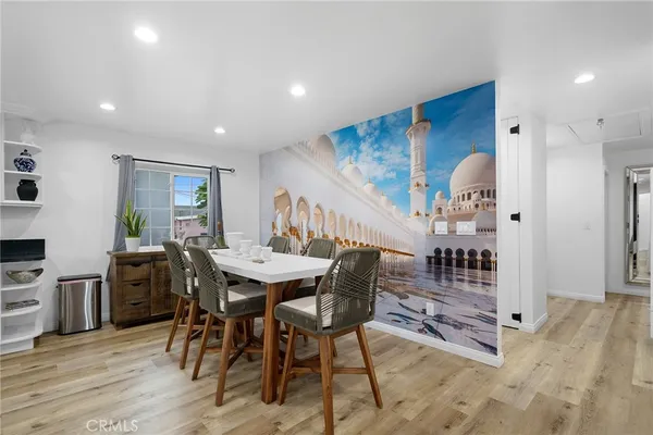 a view of a a dining room with furniture window and wooden floor