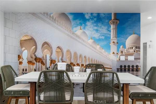 a dining room with furniture and wooden floor