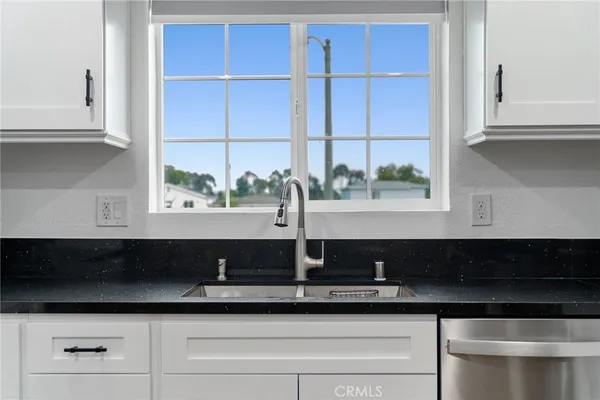 a kitchen with a sink and cabinets