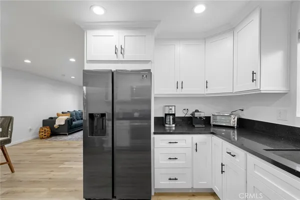 a kitchen with a refrigerator and cabinets