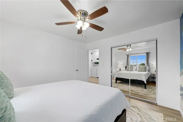 a bedroom with a bed and a lamp on dresser