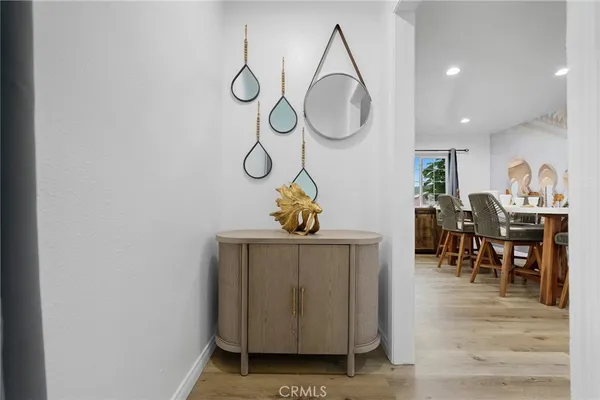 a living room with furniture a dining table and wooden floor
