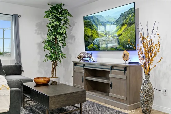 a living room with furniture and a potted plant