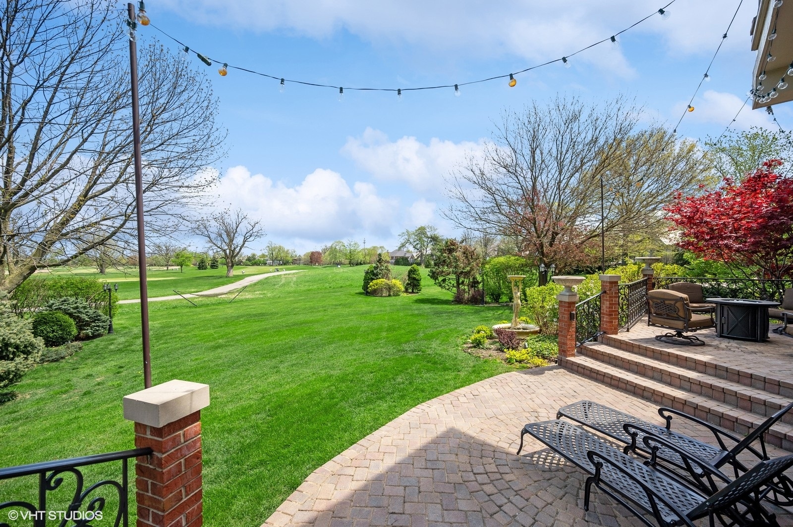 2846 Independence Avenue Glenview, IL 60026 - Photo 12 of 16 a backyard of a house with table and chairs potted plants and a large tree