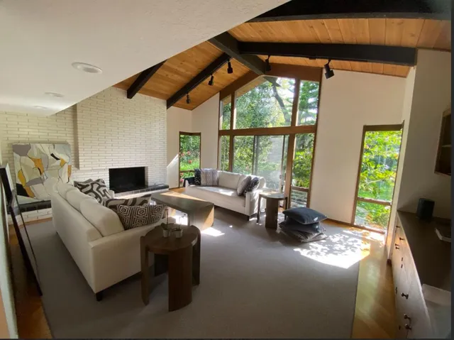 a living room with furniture and large windows