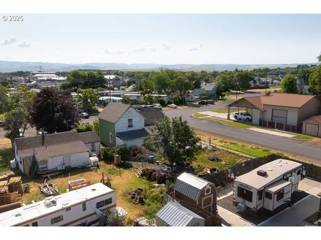 an aerial view of a house with a garden and lake view