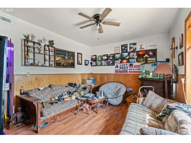 a living room with furniture and a book shelf