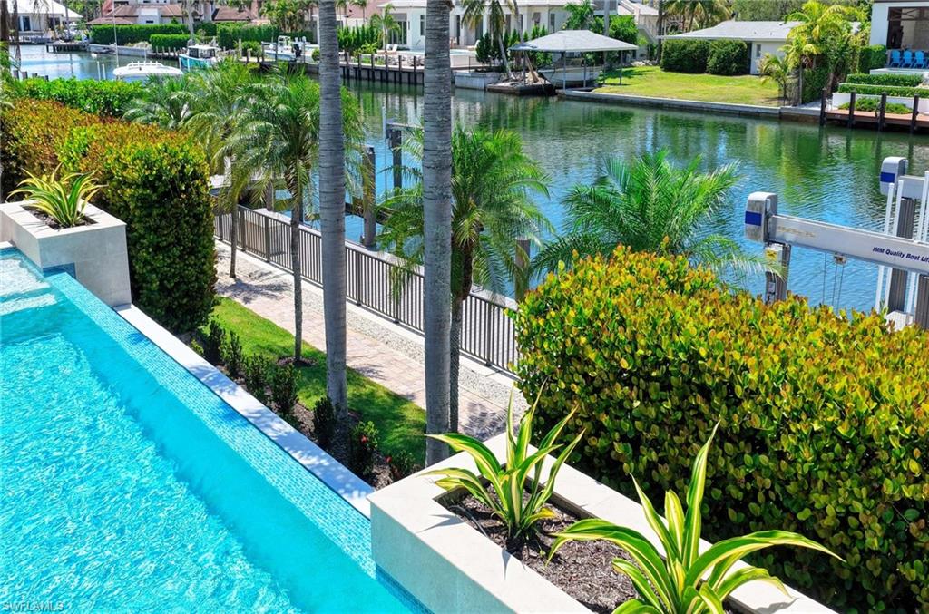 1888 6th Street South Naples, FL 34102 - Photo 17 of 37 a view of a lake with a flower garden