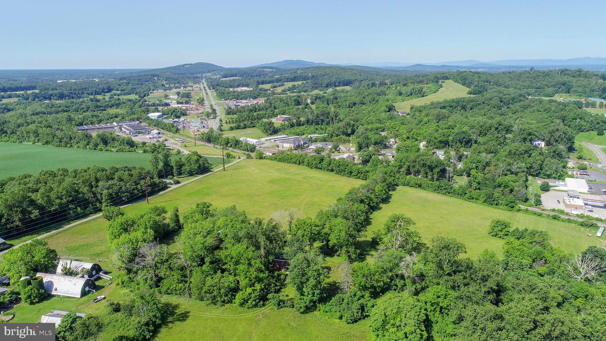 12261 Old Gordonsville Road Orange, VA 22960 - Photo 4 of 24 a view of a lush green outdoor space with a lake view