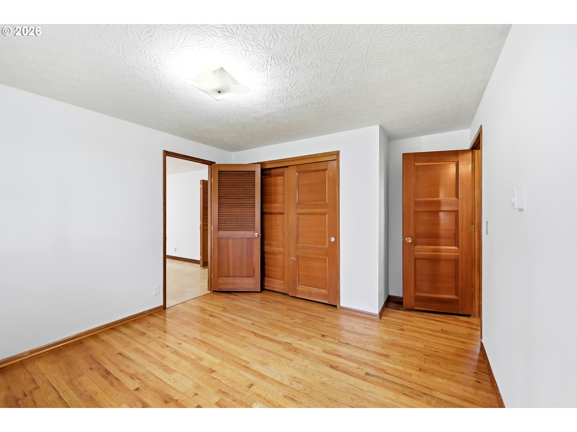 3003 Southeast 162nd Avenue Portland, OR 97236 - Photo 21 of 41 a view of an empty room with wooden floor