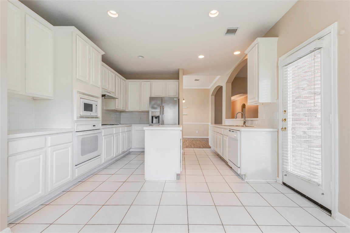 19607 Water Point Trail Humble, TX 77346 - Photo 11 of 32 Spacious kitchen featuring ample cabinetry, center island, and tile flooring.
