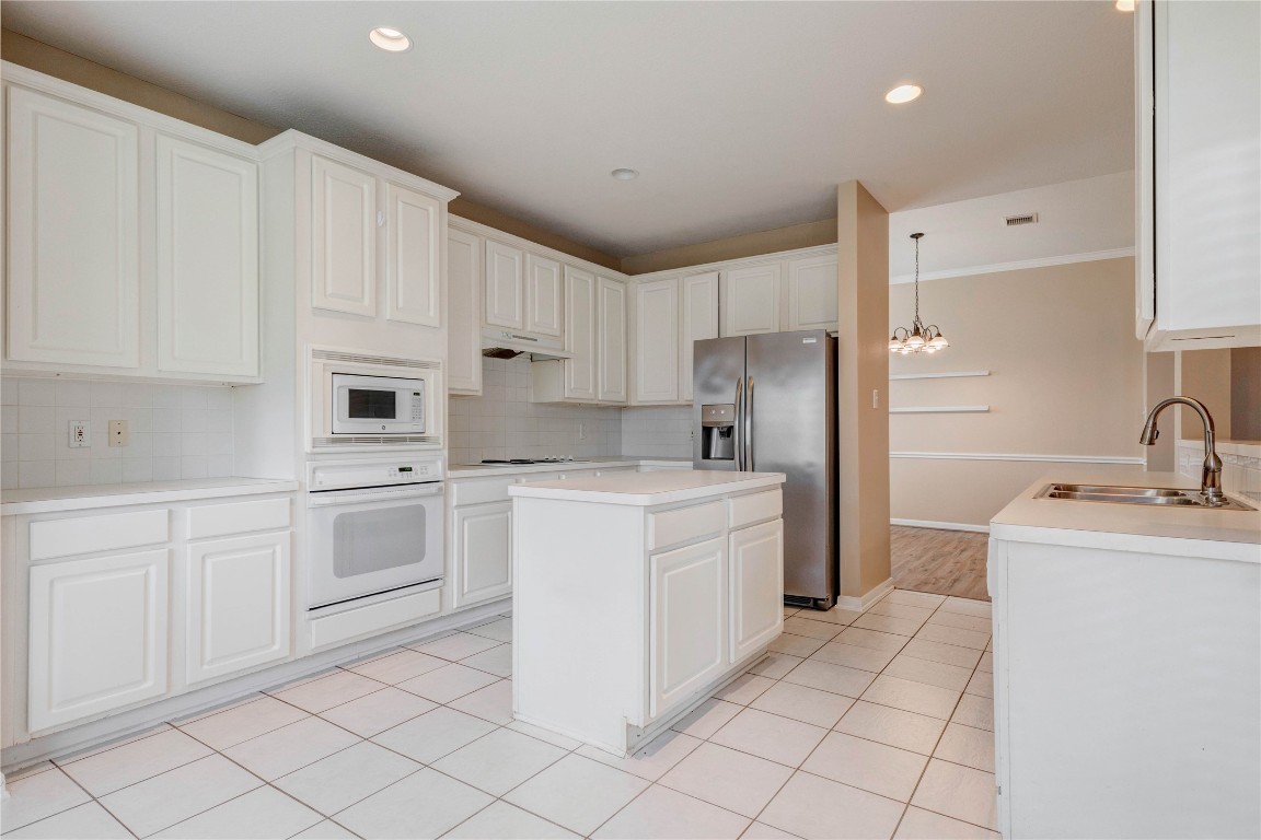 19607 Water Point Trail Humble, TX 77346 - Photo 12 of 32 Functional layout with stainless steel refrigerator, built-in appliances, and great counter space.