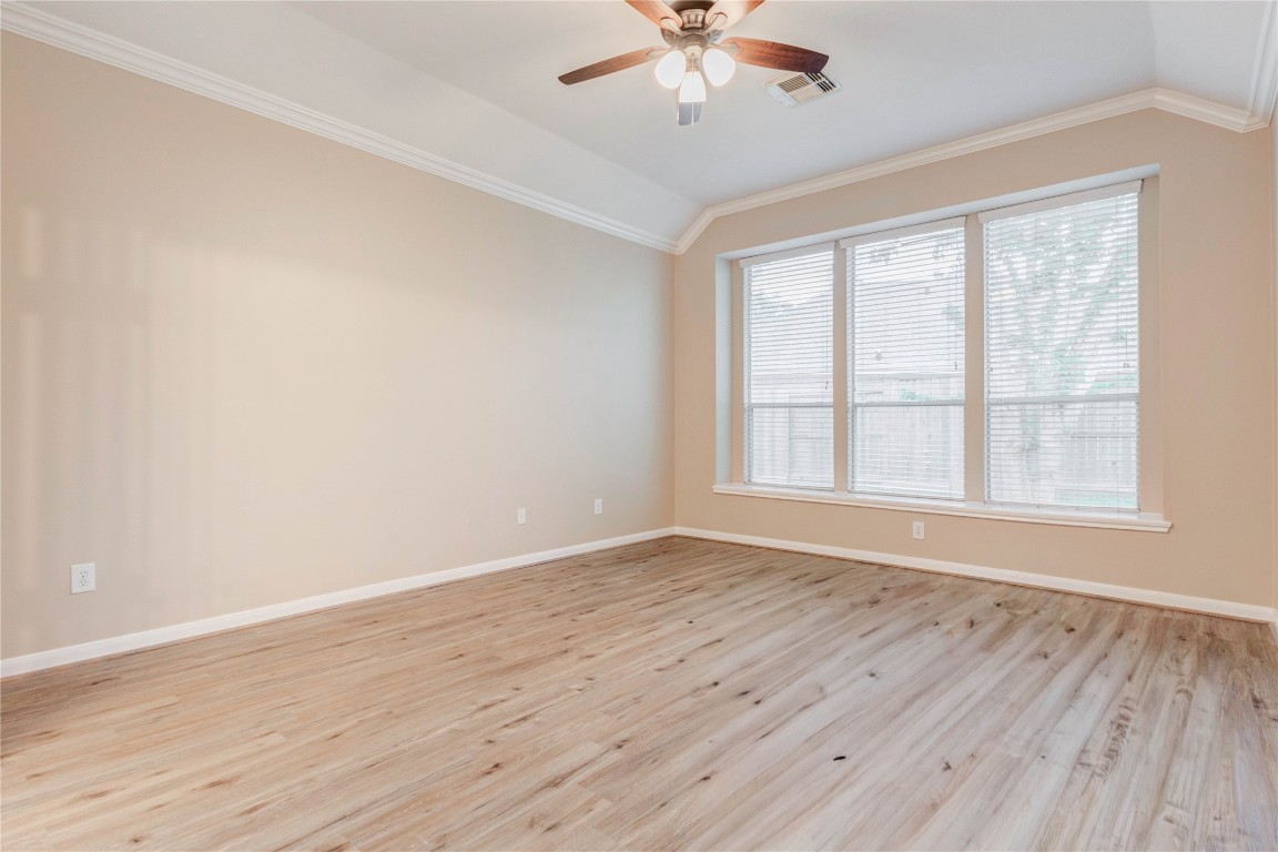 19607 Water Point Trail Humble, TX 77346 - Photo 16 of 32 Spacious primary bedroom with high ceilings, crown molding, and large windows.