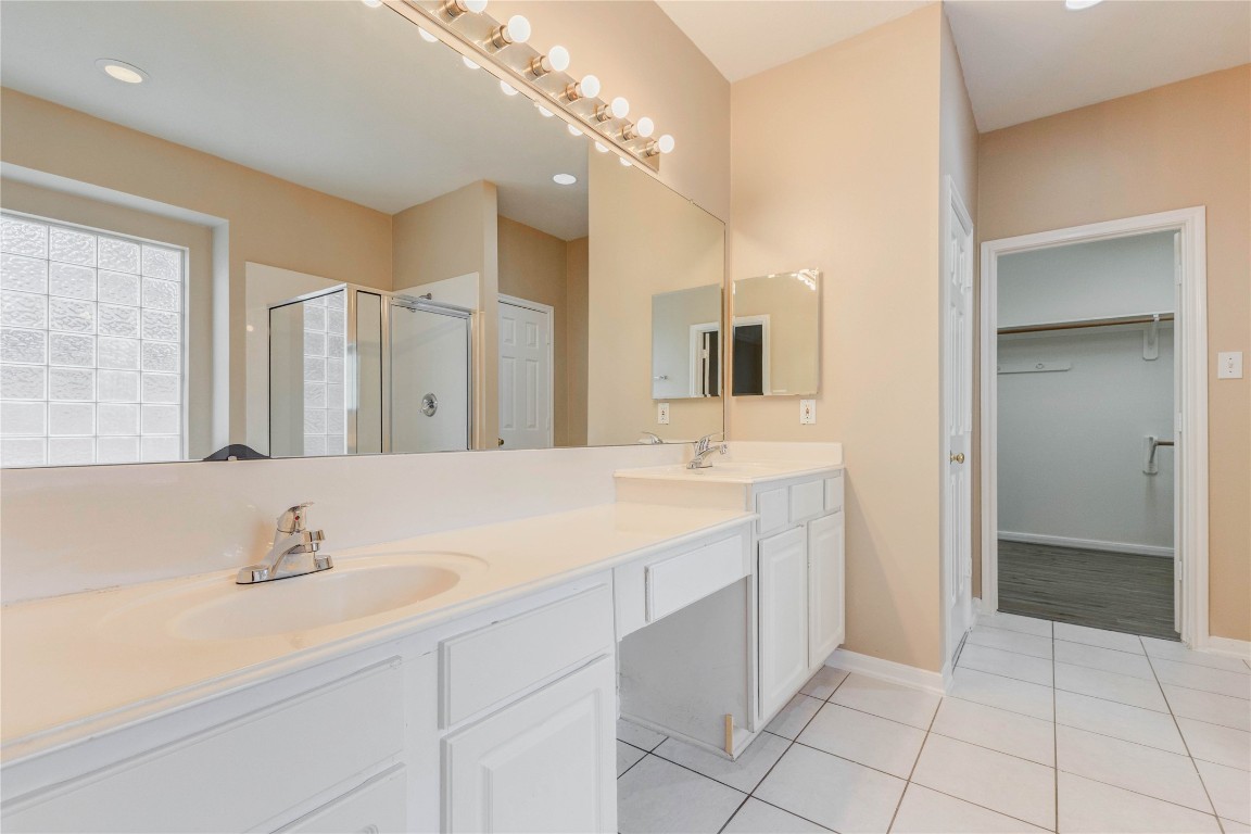 19607 Water Point Trail Humble, TX 77346 - Photo 20 of 32 Primary bathroom featuring dual sinks, large mirror, and ample counter space.