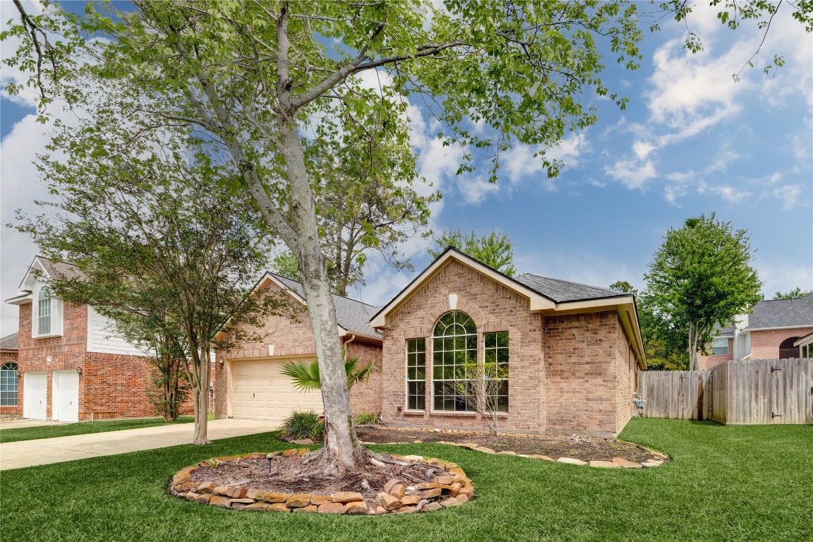 19607 Water Point Trail Humble, TX 77346 - Photo 2 of 32 Spacious front yard with large shade tree and charming brick exterior.