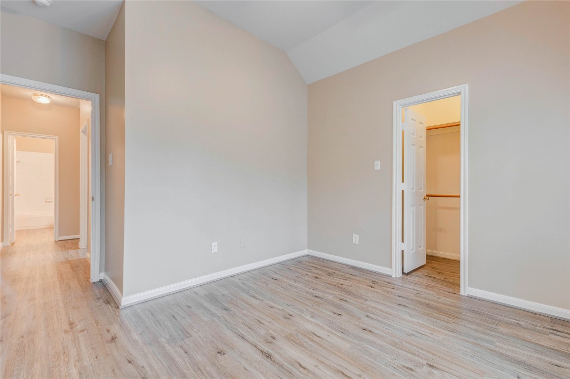 19607 Water Point Trail Humble, TX 77346 - Photo 25 of 32 Spacious guest bedroom featuring high ceilings, updated flooring, and a walk-in closet.