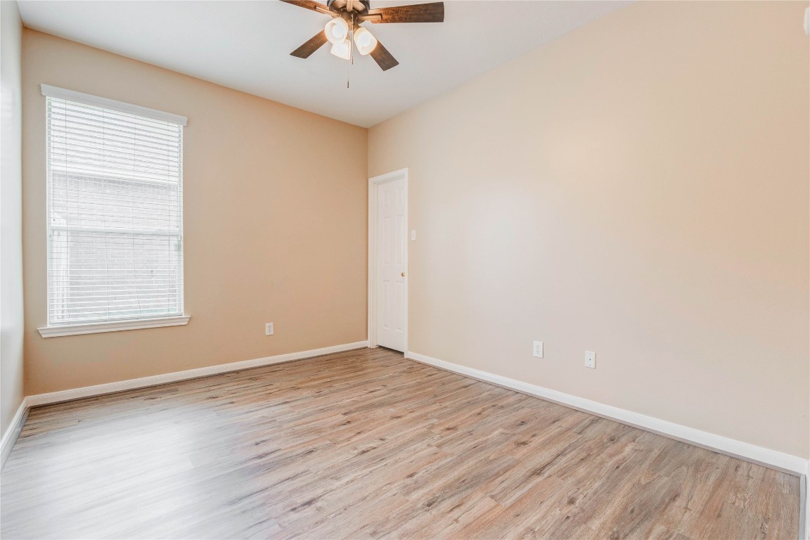19607 Water Point Trail Humble, TX 77346 - Photo 26 of 32 Bright secondary bedroom with natural light, updated flooring, and ceiling fan.