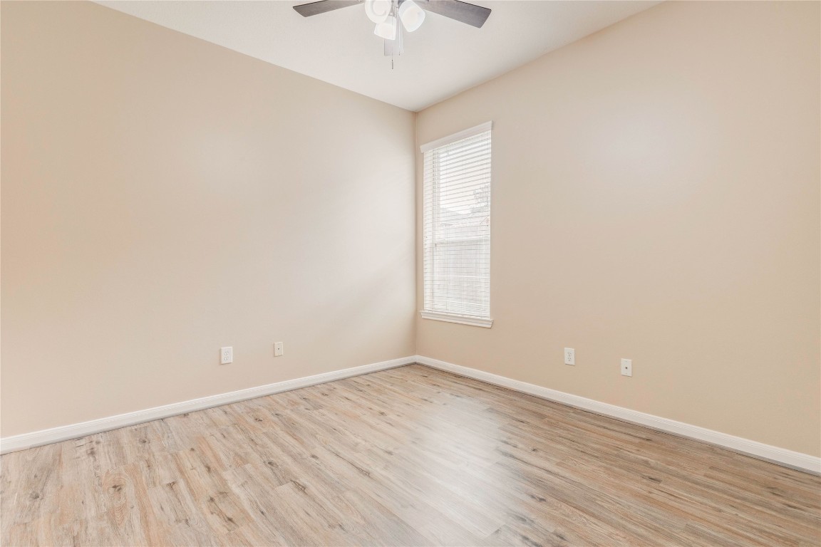 19607 Water Point Trail Humble, TX 77346 - Photo 27 of 32 Bright secondary bedroom with natural light, updated flooring, and ceiling fan.