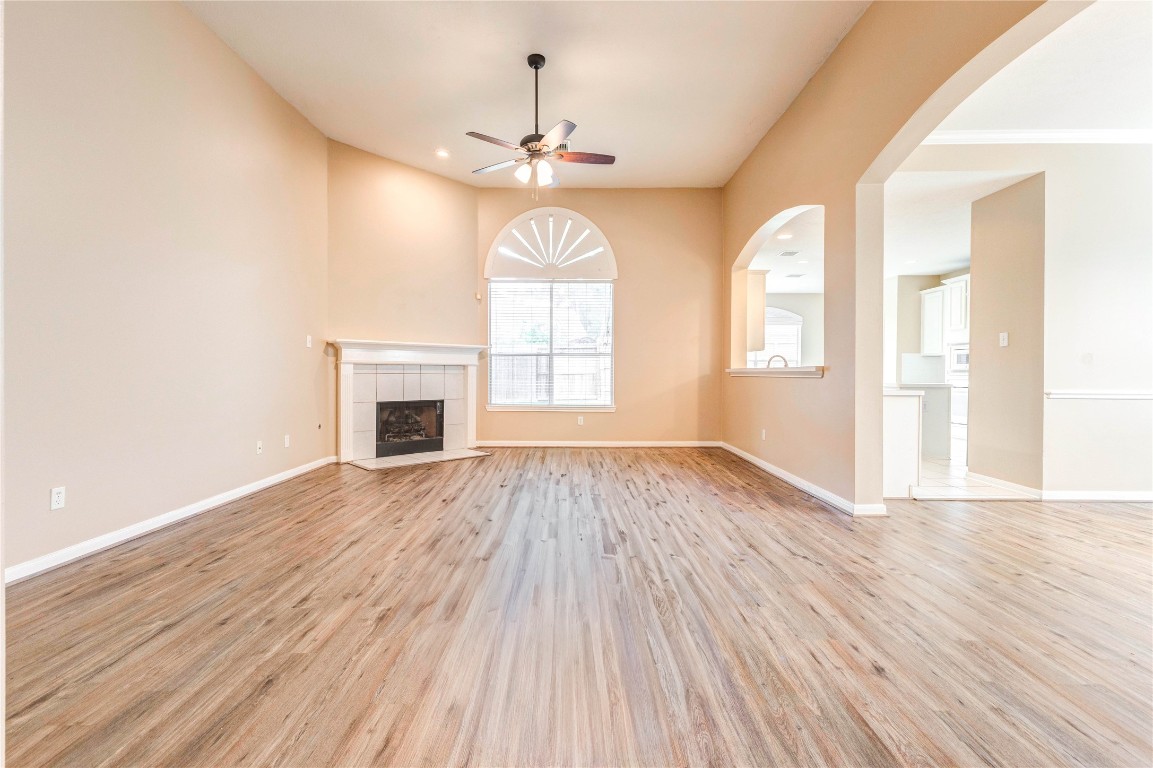 19607 Water Point Trail Humble, TX 77346 - Photo 4 of 32 Spacious living room with high ceilings, updated flooring, and cozy fireplace.