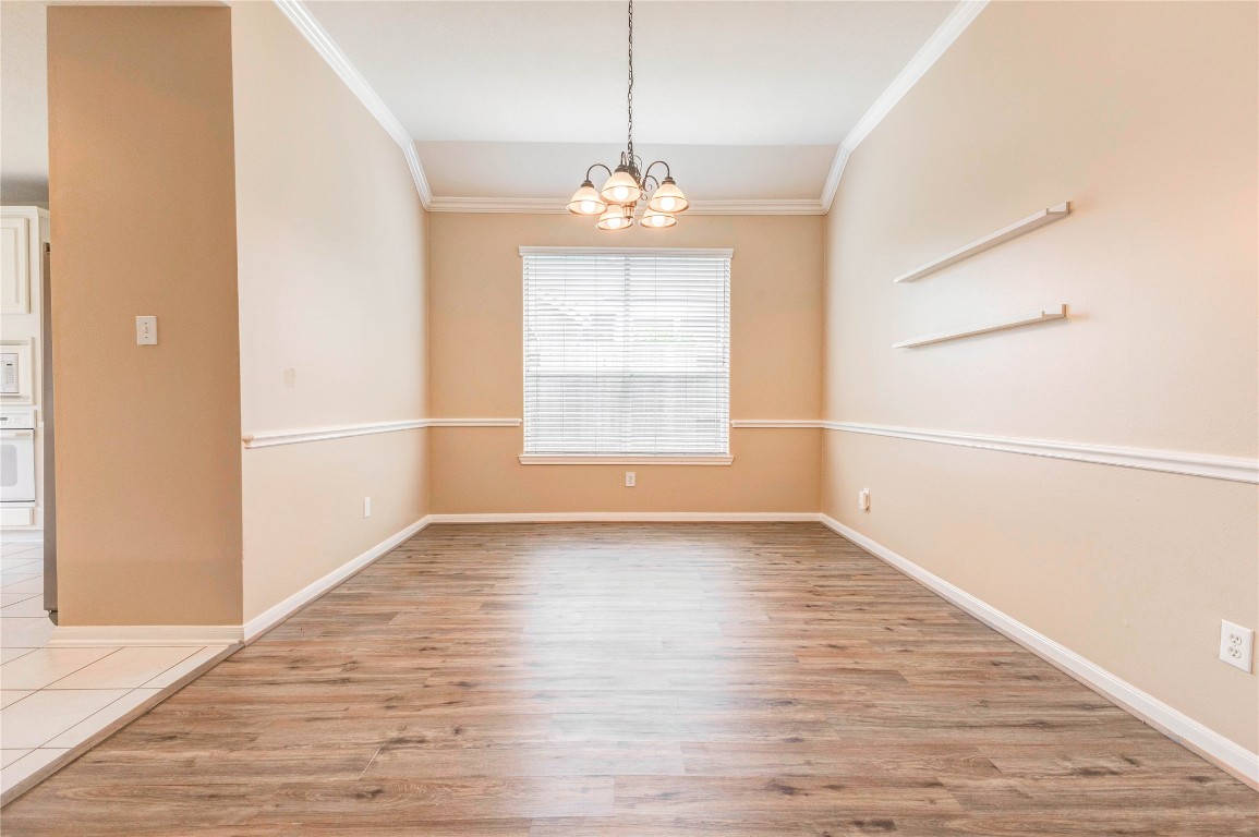 19607 Water Point Trail Humble, TX 77346 - Photo 9 of 32 Formal dining area with crown molding and elegant lighting fixture.