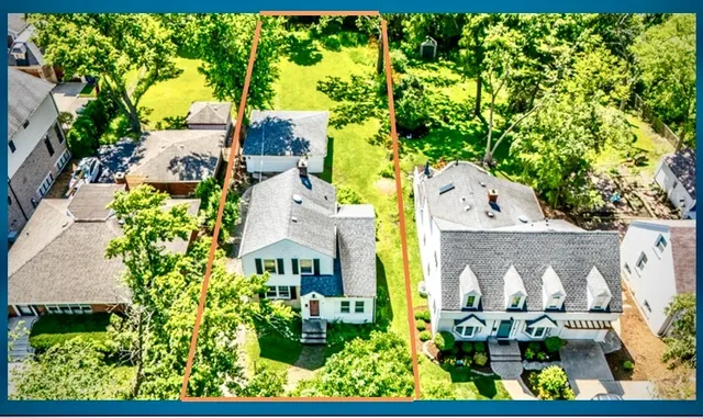 an aerial view of residential houses with outdoor space and street view