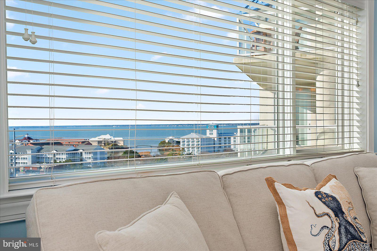 8 60th Street, Unit 902 Ocean City, MD 21842 - Photo 12 of 67 a living room with furniture and a floor to ceiling window