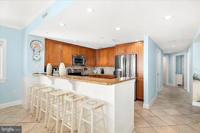 a bedroom with a large bed and a flat tv screen on dresser