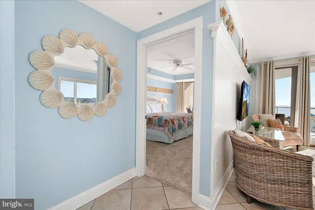a bedroom with a bed and a dresser next to a window