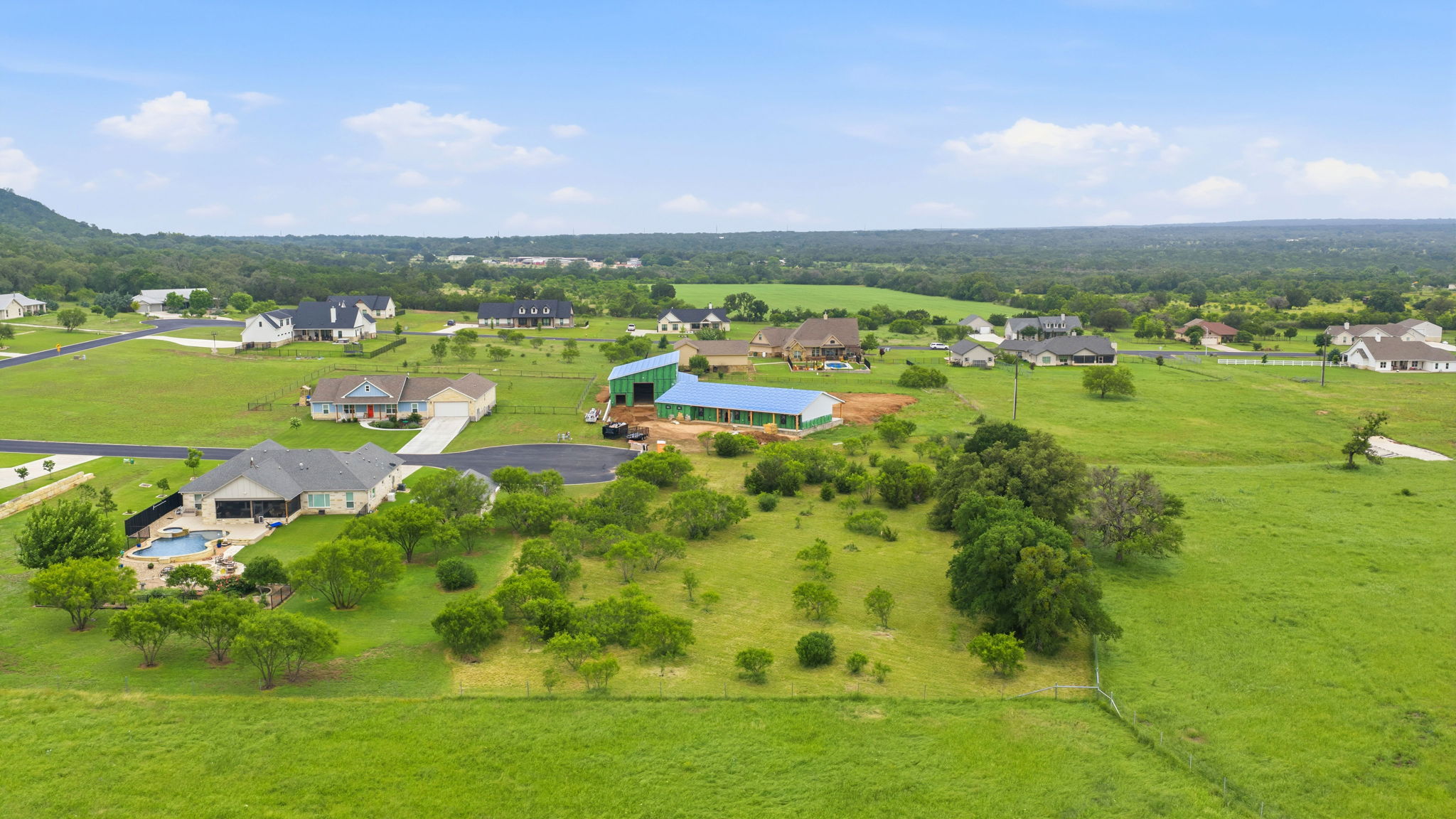 104 Round Up Circle Burnet, TX 78611 - Photo 15 of 23 Expansive green landscape featuring varied terrain and scattered trees