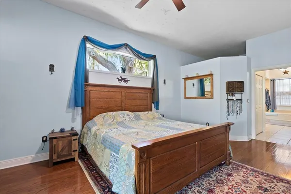 a spacious bathroom with a tub shower and mirror