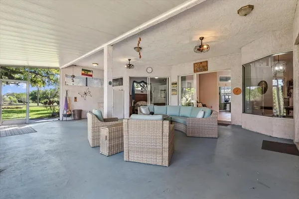 a view of a chair and table in backyard of the house